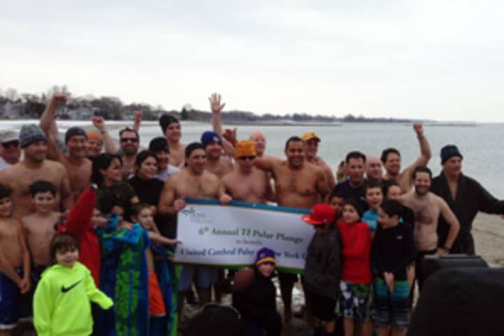 The TI Polar Bears huddle for a quick photo before plunging into the frigid waters of Long Island Sound.