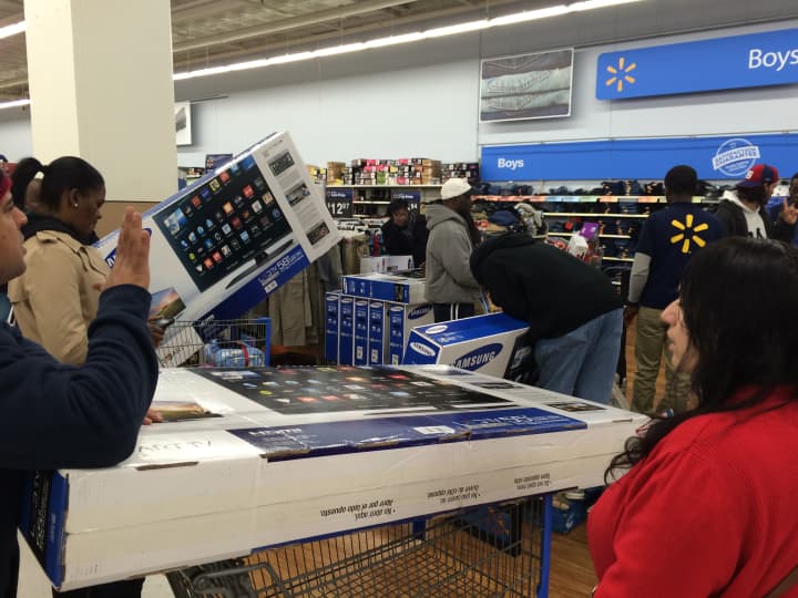 Keifer Davis of White Plains checks out with her merchandise at Walmart in White Plains on Thanksgiving night.