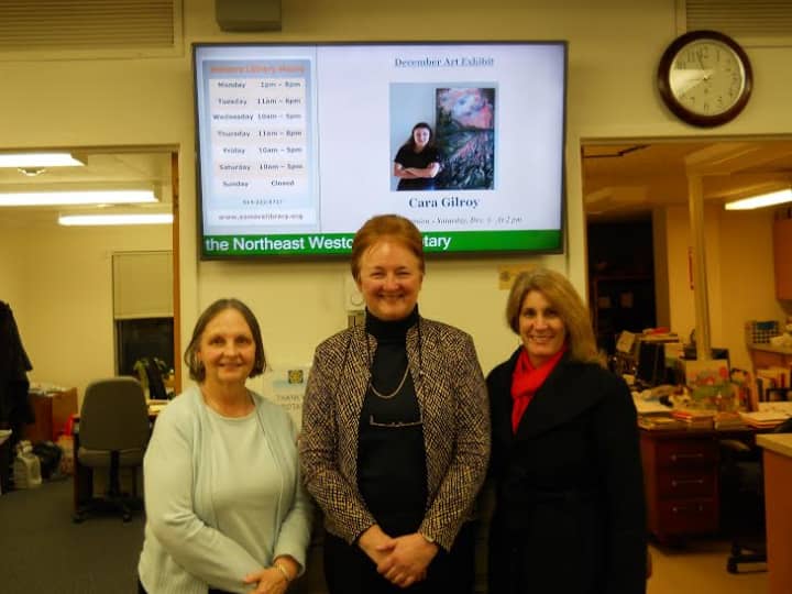 Susan Petroccione, Pat Miller and Rose Corbett show off the library&#x27;s new display screen.