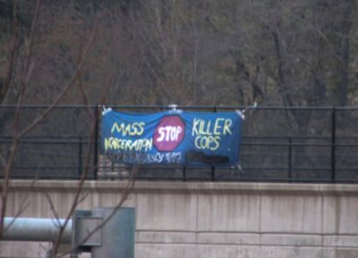 Sign dangling from an overpass along Interstate 287 in White Plains on Monday, Dec. 1.
