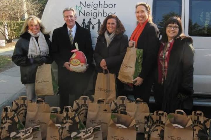 Employees of Berkshire Hathaway New England Properties joined forces with Neighbor to Neighbor to provide Thanksgiving food for needy families.