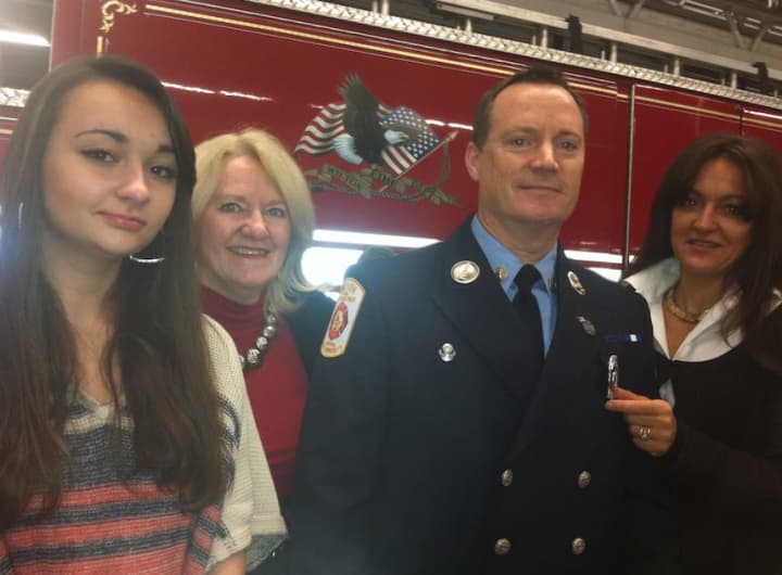 Newly promoted Wilton Fire Department Lt. Jeffery Locher with, from left daughter Jacqueline, sister Melinda Locher McCreary and his wife Tracy. He was sworn in on Monday.