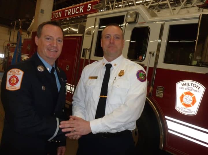 Greenwich Fire Department Assistant Fire Chief Robert Kick, at right, congratulates new Wilton Fire Department Lieutenant Jeffery Locher on his promotion Monday in a ceremony held in Wilton. Locher started his professional career in Greenwich.