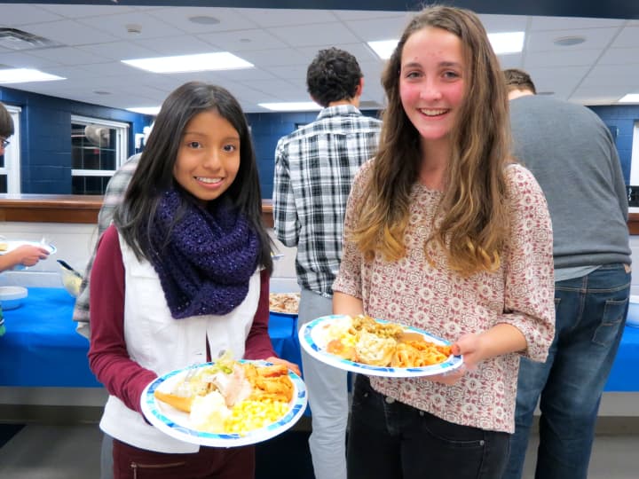 Croton-Harmon High School TAP students fill their plates with Thanksgiving food.