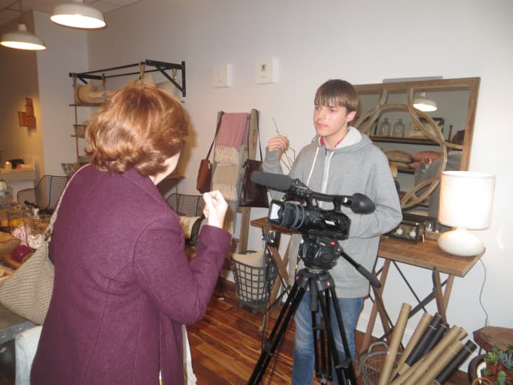 Larchmont Mayor Anne McAndrews talks to a local camera crew during the recent grand opening of Village Mercantile.