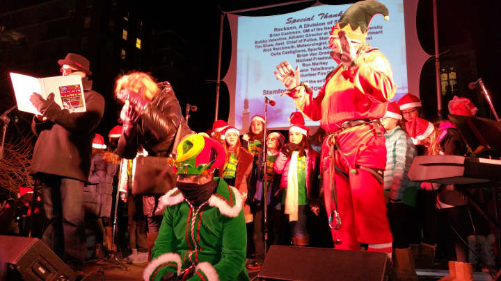 New York Yankees General Manager Brian Cashman (center, green) and Former New York Mets Manager Bobby Valentine (right, red) stand on stage as guest stars to Stamford&#x27;s Holiday Tree lighting finale.