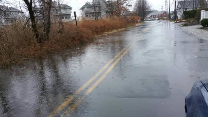 The roadway is covered with water Tuesday morning along Fairfield Beach Road. 