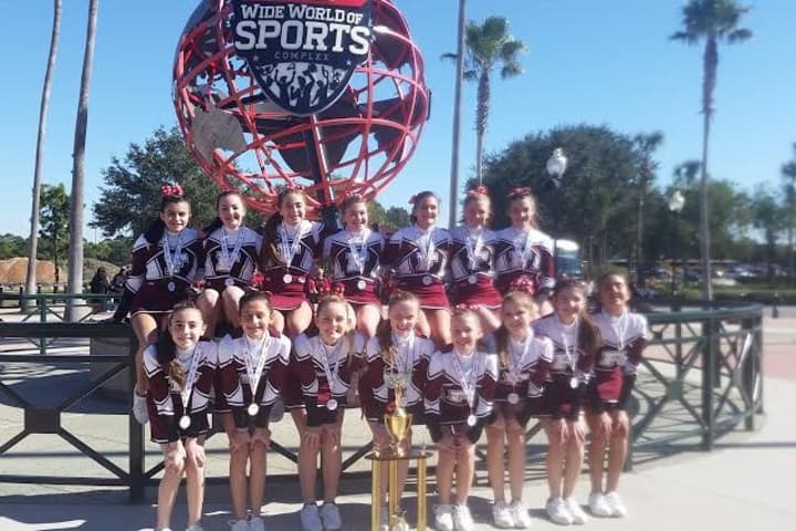 Fairfield Giants Junior Midget cheerleaders stand with their trophy after finishing second Wednesday at the Pop Warner National Cheer and Dance championships in Orlando.