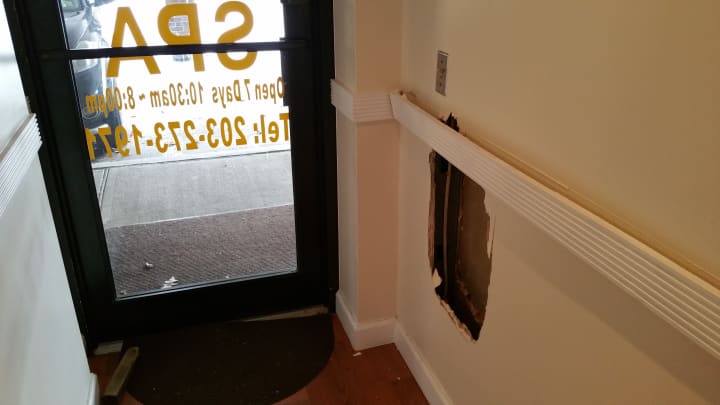 Fairfield Police said the burglar was able to gain entrance to the spa through this hole in the wall.
