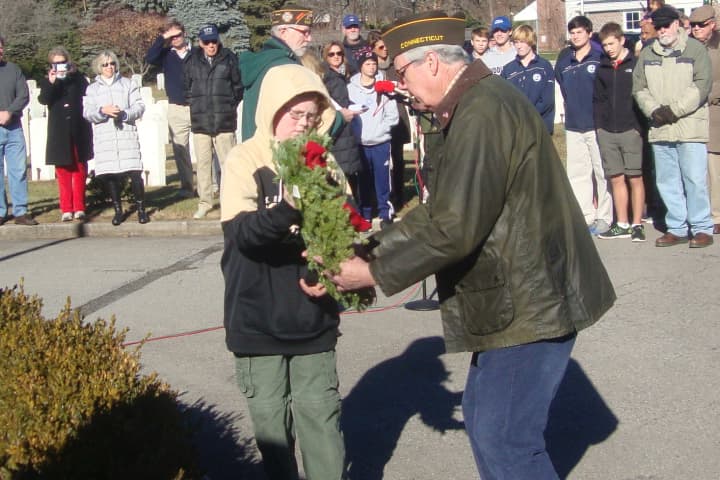 Veteran John Driscoll and Boy Scout Michael Parkhurst lay one of seven ceremonial wreaths in honor of the different branches of the armed services at the Wreaths Across America ceremony in Darien.