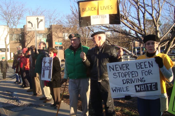 Protesters on both sides of the bridge in downtown Westport held up signs and protested the treatment of African Americans by police Saturday.
