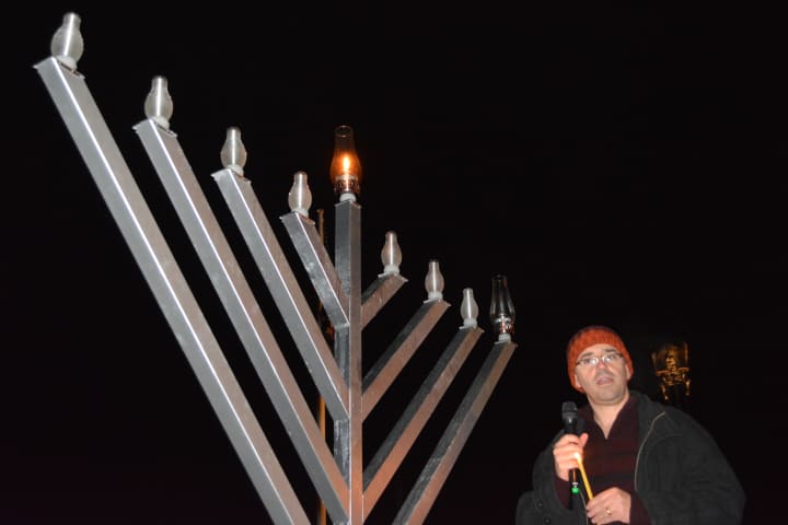 Somers resident Jim Laredo stands next to the menorah prior to lighting the candle for the first night.