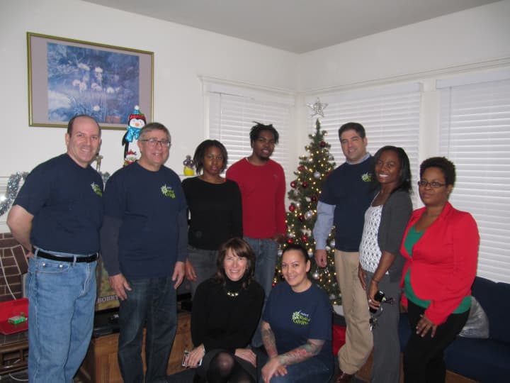 Clients of the Keystone House are surprised with Christmas trees and decorations by employees of Tauck, Inc.