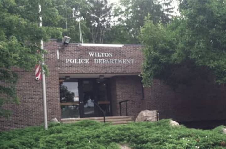 Wilton Police charged a man who allegedly grabbed and pushed his girlfriend during a dispute as they decorated a Christmas tree on Saturday.