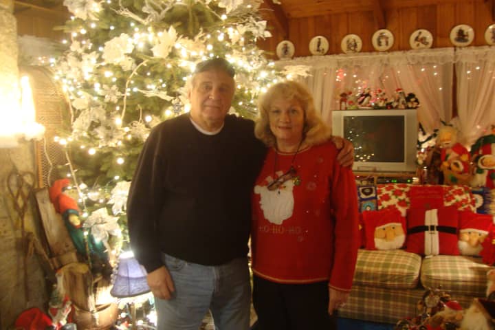 Rick and Joan Setti in their living room, which is just as adorned with Christmas decorations as their front lawn.