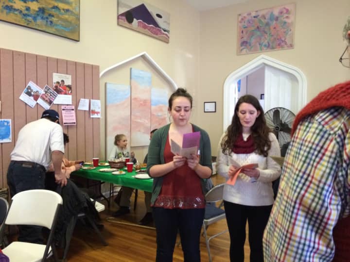 Volunteer Emily Code and others singing songs at the Christmas dinner last year.