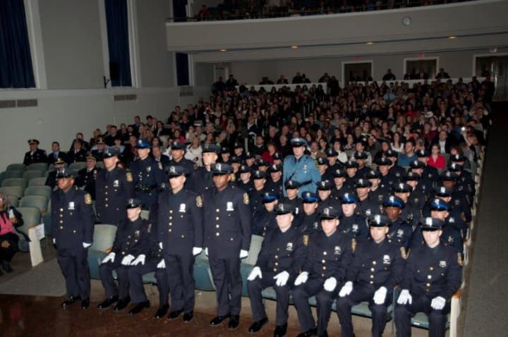 The 138th basic police recruit class at Friday&#x27;s graduation. The officers standing were recognized for prior military service.