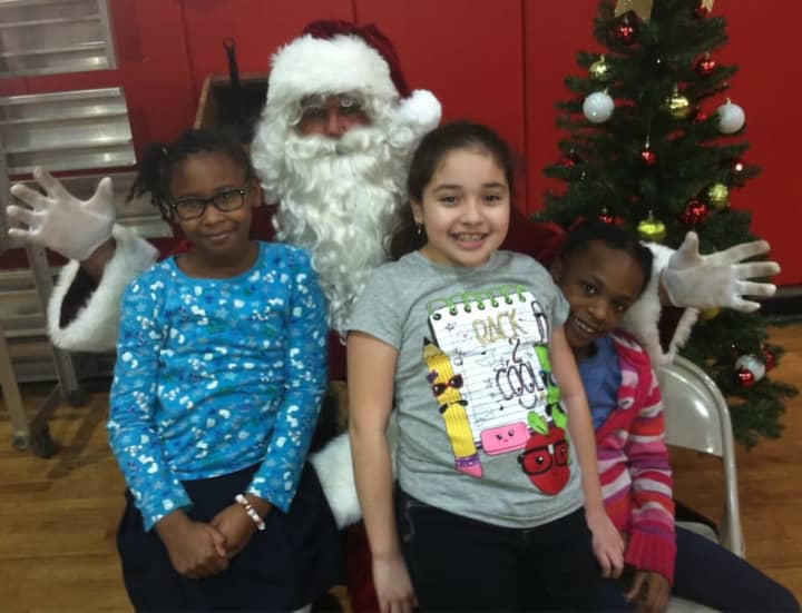 Santa Clause showed up at the Stamford Boys &amp; Clubs Club Friday during the club&#x27;s annual holiday dinner. From left are: Jasmine Stroud, 8, Santa, Melisa Aguirre, 9, and Zenayn Dixon, 8.
