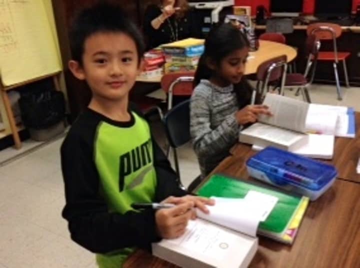 Todd Elementary School third-graders in Briarcliff Manor flipped through dictionaries gifted to them by the Briarcliff Manor Rotary Club.
