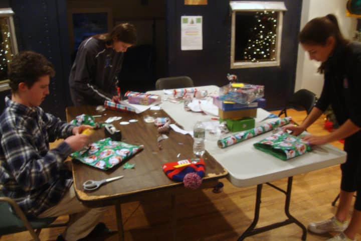 Nick Murphy, Kerry Blatney and Laura Schwartzman wrap gifts during the Depot&#x27;s 2014 Wrap Up event.