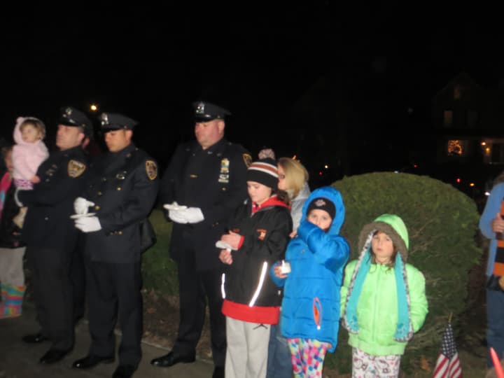 Village of Mamaroneck police officers stand with some of their children during a vigil Monday night.