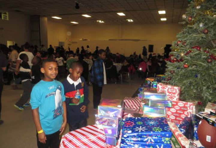 White Plains children check out the presents before they were handed out by Batty&#x27;s Kids on Christmas Eve