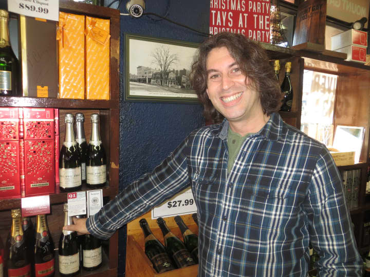 Jake Lambertson, wine buyer and manager at Post Wine and Spirits in Larchmont, poses next to his favorite champagne, Philippe Prie. 