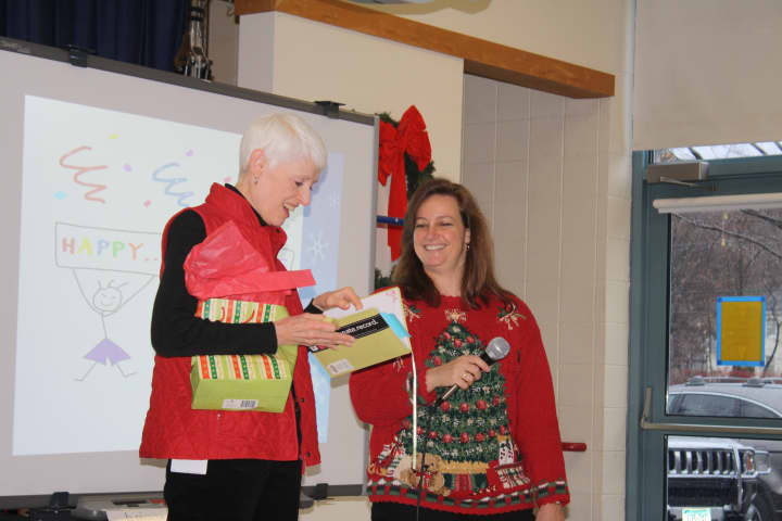 Nancy Albrizio, left, accepts gifts from Holmes principal Paula Bleakley.