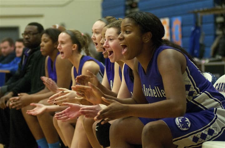 New Rochelle girls cheer teammates from bench.