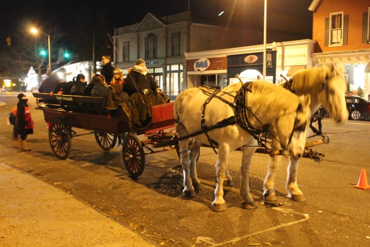 Horse-drawn carriages offer rides to revelers at the Westport Weston First Night. 