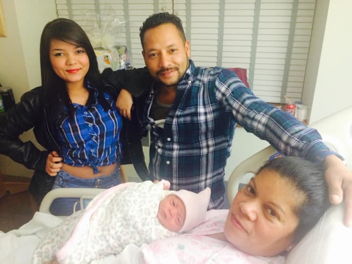 The family gathers Thursday for the birth of Ella Natasha Amaya-Rodriguez, the first baby born in the New Year at Norwalk Hospital.