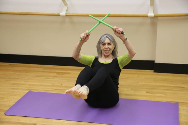 Peggy Raiskums shows off a squat in her new POUND Fitness class.