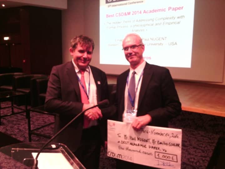 Paul Nugent, right, WCSU associate professor of management information systems accepts the 2014 Best Academic Paper Award from Daniel Krob, chairman of the Fifth International Conference on Complex Systems Design and Management.