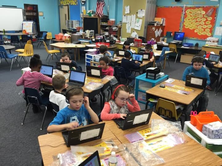 Students in Mary Fanning&#x27;s first-grade class work on reading software on the first day of the mobile-learning program pilot.
