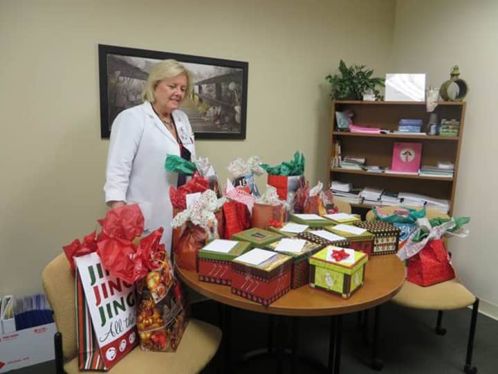 Dianne Toscano, Putnam Hospital Centers oncology nurse navigator, looks over the care packages donated by Carmel High Schools Cancer Awareness Club.