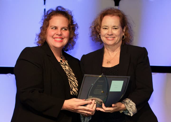 During the 2014 OLC Awards in Orlando, Fla., in October, Sandra Coswatte, director of the OLC Institute for Learning,left, presents the Effective Practice Award to professor Marie Hulme who won for SHUsquare along with Jaya Kannan.