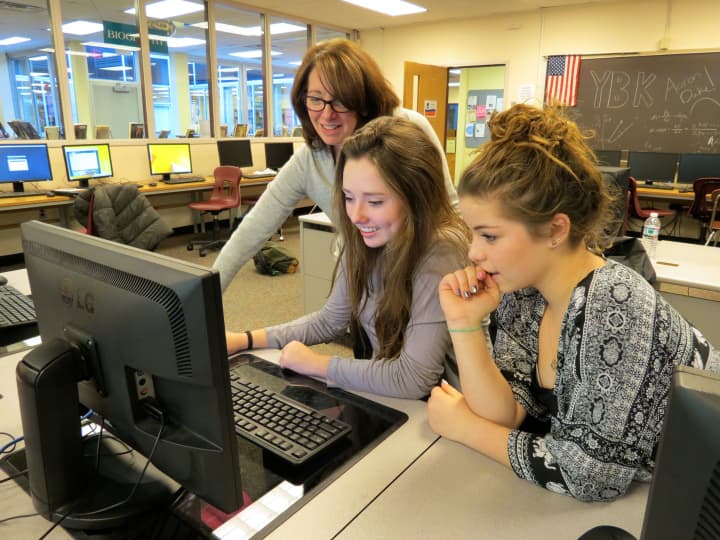 Briarcliff High School Yearbook Club adviser Nina Marcel worked with student staff members on layout decisions for the 2015 publication.