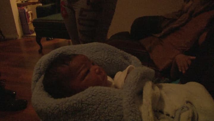 Baby JaKhi was born in his Bridgeport home on Friday, delivered by firefighters and medics. 