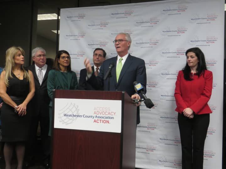 Westchester County Association Chairman William Harrington speaks at Tuesday&#x27;s news conference, with WCA President Marissa Brett, right, and college and hospital leaders.