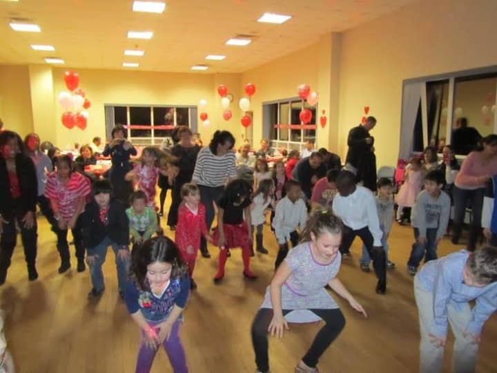 Parents and children have fun at a previous Valentine&#x27;s dance.