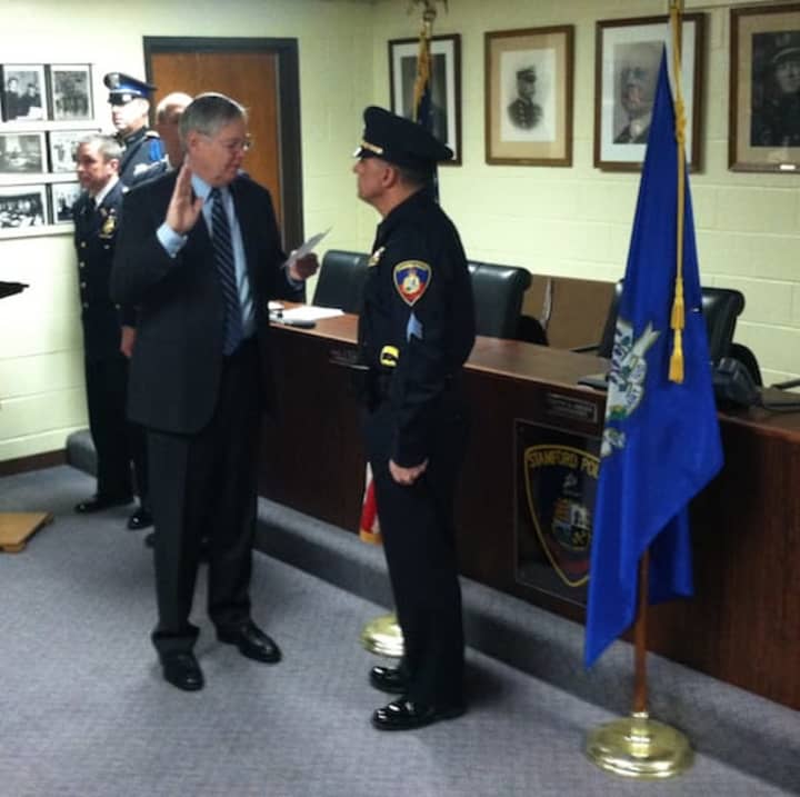 Stamford Mayor David Martin swears Sgt. Doug Deiso during a ceremony Tuesday at police headquarters.