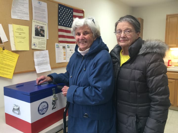 Old Town Hall Houses residents Kate Taylor (left) and Georgette Ferrante (right) exercise their civic right to elect a Tenant Commissioner to the Darien Housing Authority. 