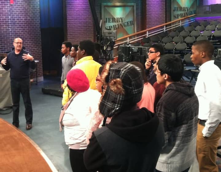 Adam Soroto, at left, senior director, explains how &quot;The Jerry Springer Show&quot; is produced while Future 5 students are on the set during a tour of NBCUniveral&#x27;s Stamford Media Center.