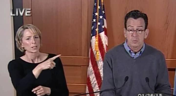 Gov. Dannel P. Malloy speaks during a 5 p.m. briefing as his sign language interpreter translates his comments in this image taken from CT-N.com.