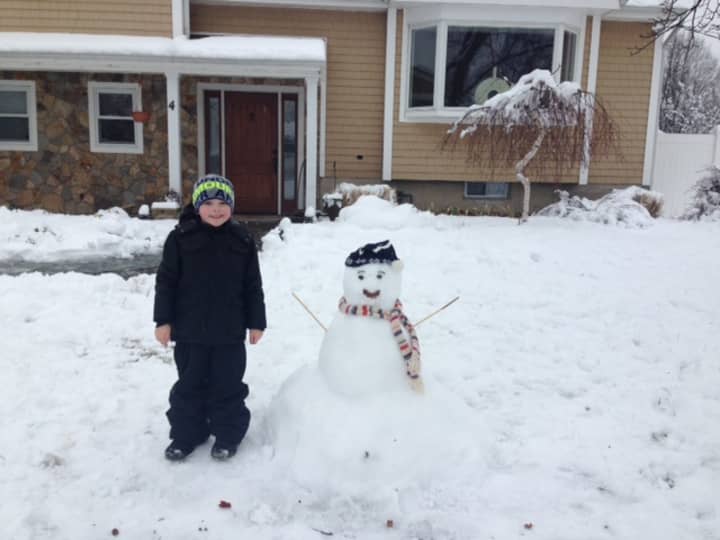 Jakob Sweeters makes the first snowman of the year. 