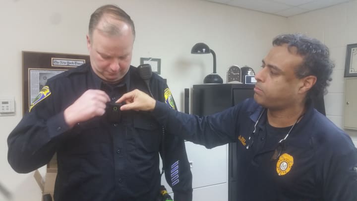 Lt. Perez (right) and Officer Fenton demonstrate how the camera is activated by simply uncovering the lense.