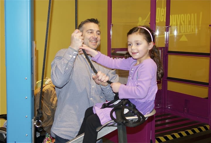 Emma Hendricks, 6, of Wilton, gets a lift with the help of dad, Jerry.