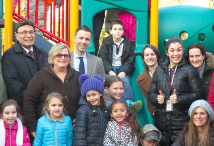 Park Childhood Center students, school officials and developer Martin Ginsburg, far left, at the center&#x27;s new playground.