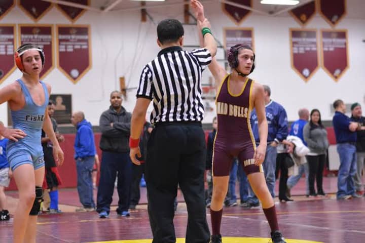 Sam White of the Norwalk Mad Bulls has his arm raised in victory after stunning state champion Hunter Adams in the finals of a tournament last weekend in South Windsor.