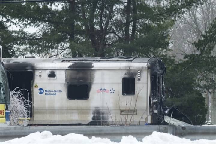 Metro-North workers towed away the damaged train car from Tuesday&#x27;s crash, and service has resumed on the Harlem Line.